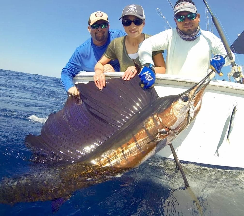 A couple releases a sailfish boatside with the mate, Big Buoys Guatemala