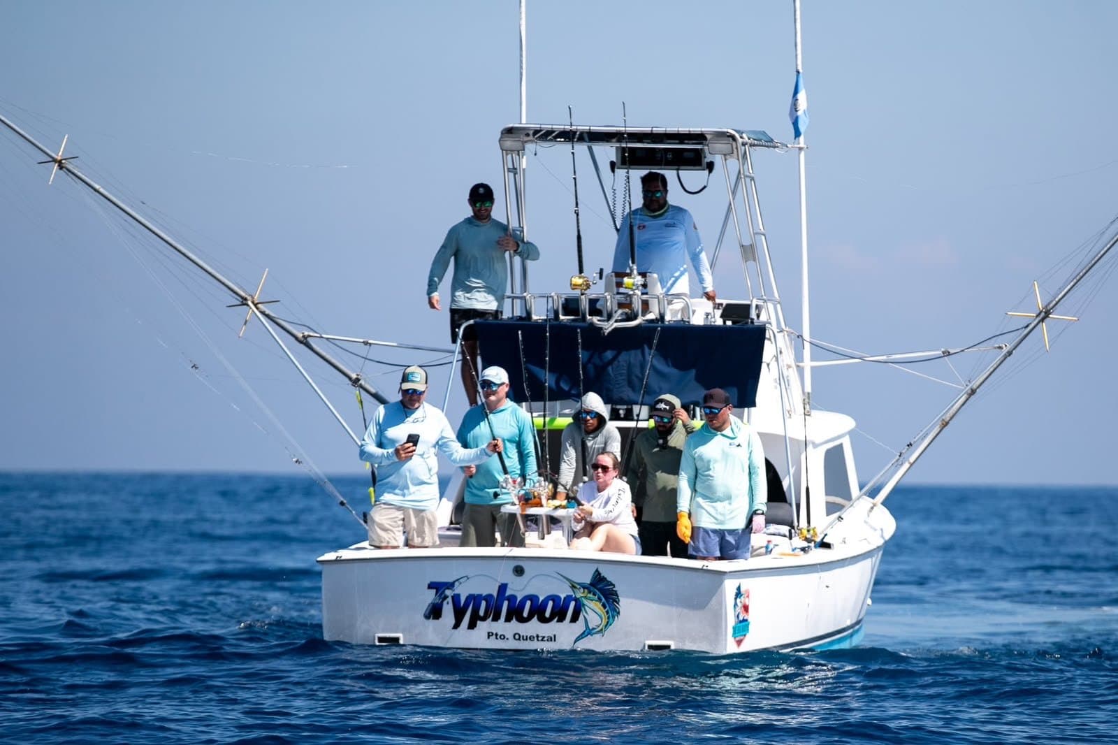 The Big Buoys boat Typhoon head-on with the full crew and the Guatemalan flag offshore Puerto San José, Guatemala