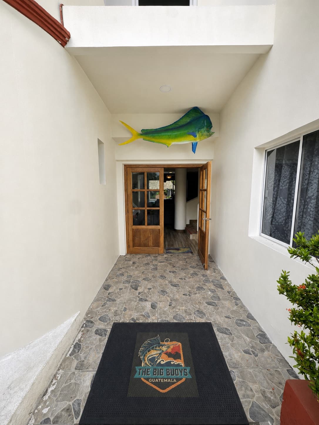 Entry hallway with the Big Buoys logo inlaid in the floor at the Big Buoys villa, Puerto San José, Guatemala