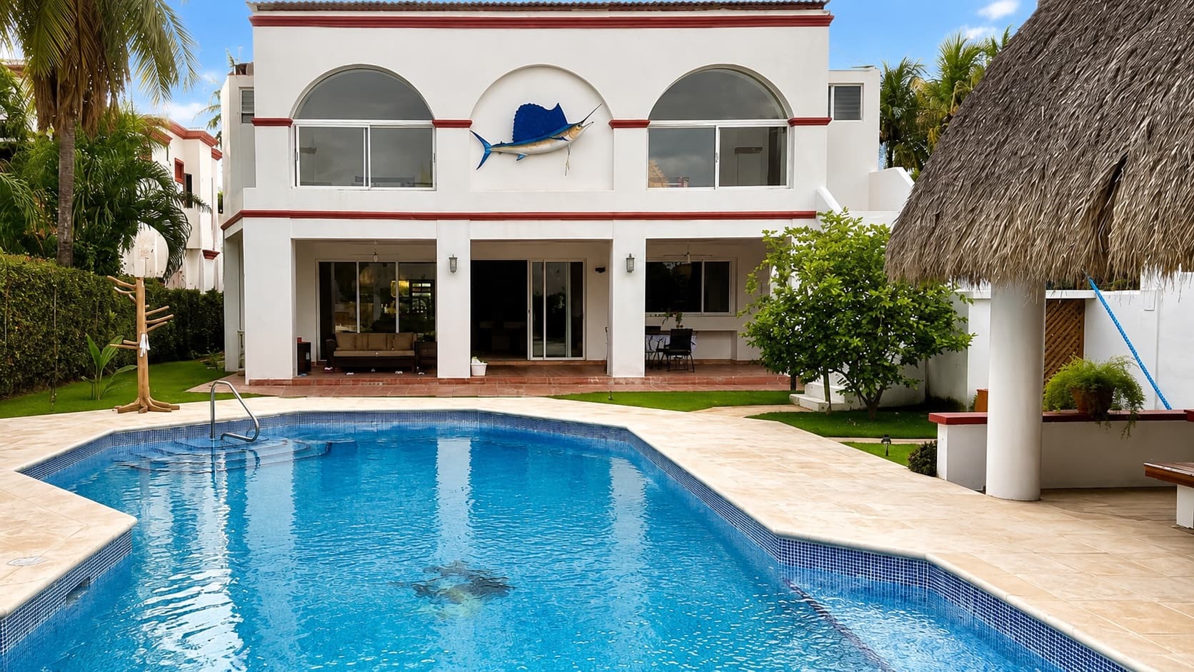 The Big Buoys villa with its pool and thatched palapa in Puerto San José, Guatemala